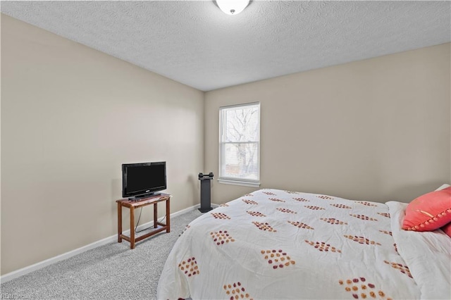 bedroom featuring carpet floors and a textured ceiling