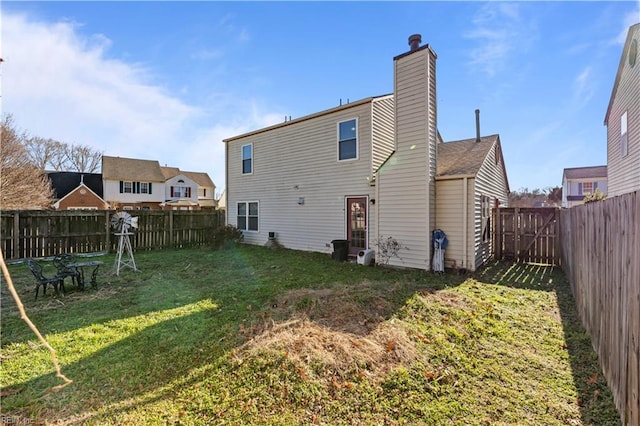 rear view of house with a yard