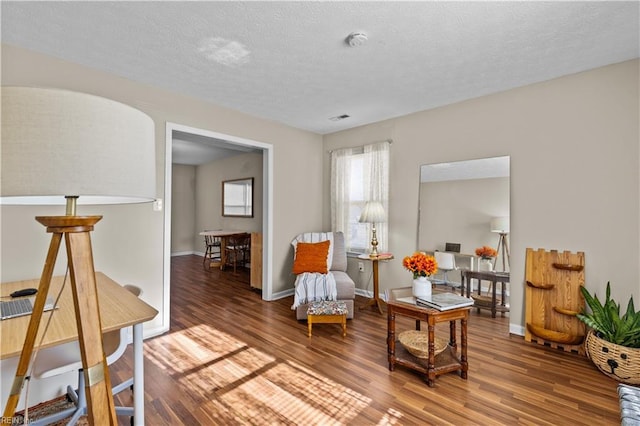 sitting room featuring hardwood / wood-style floors and a textured ceiling