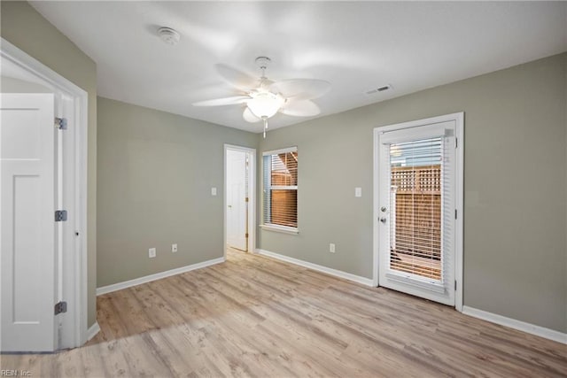 spare room with a ceiling fan, baseboards, visible vents, and light wood finished floors