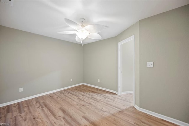 empty room with baseboards, visible vents, a ceiling fan, and light wood-style floors