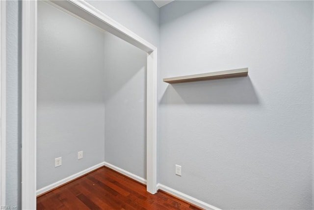 spacious closet with dark wood-style floors