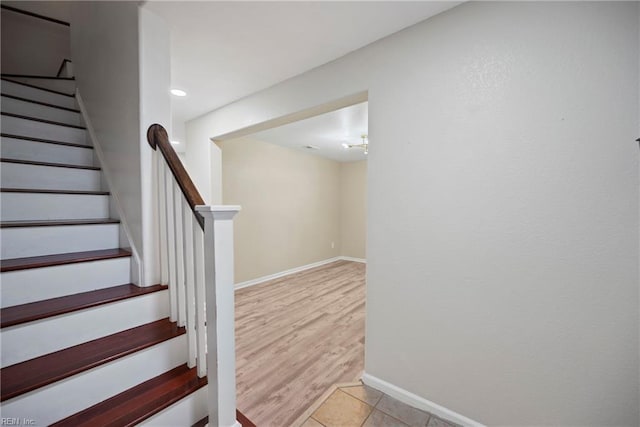 staircase with wood finished floors and baseboards