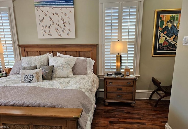 bedroom with dark wood-type flooring