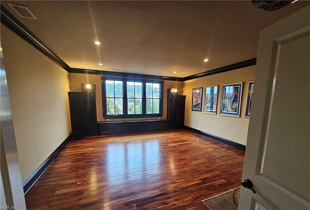 unfurnished room featuring ornamental molding and dark hardwood / wood-style flooring