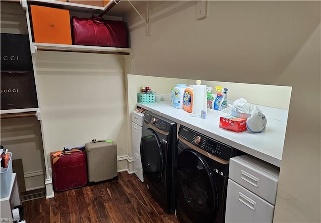 clothes washing area featuring washing machine and dryer and dark hardwood / wood-style flooring