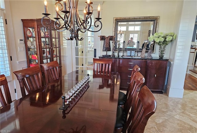 dining space with a notable chandelier and french doors