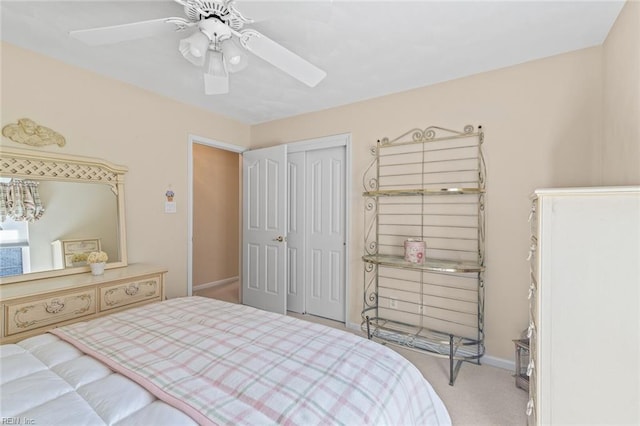 carpeted bedroom featuring ceiling fan and a closet