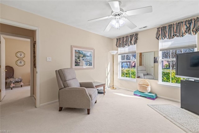 sitting room with ceiling fan, carpet, and a wealth of natural light