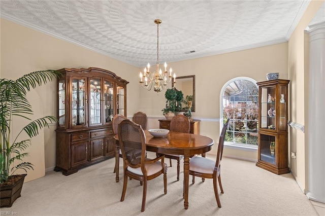 carpeted dining room with ornamental molding and a chandelier