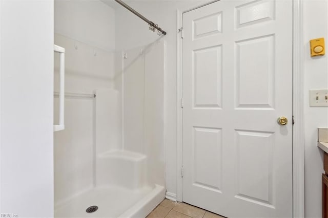 bathroom with vanity, tile patterned flooring, and a shower