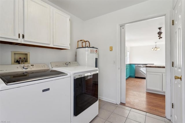 laundry room with light tile patterned floors, water heater, cabinets, washing machine and clothes dryer, and a chandelier