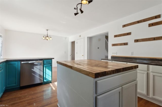 kitchen featuring a kitchen island, wood counters, decorative light fixtures, dishwasher, and dark wood-type flooring