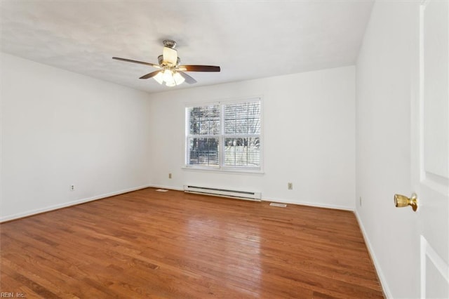 empty room with a baseboard heating unit, hardwood / wood-style floors, and ceiling fan