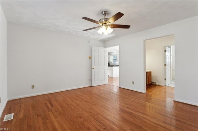 interior space with ensuite bathroom, ceiling fan, and light hardwood / wood-style flooring