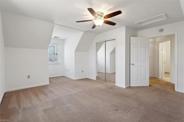 additional living space with lofted ceiling, light carpet, and ceiling fan