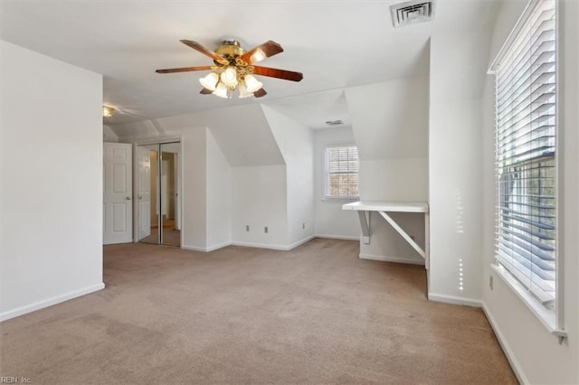 bonus room featuring lofted ceiling, light carpet, and ceiling fan