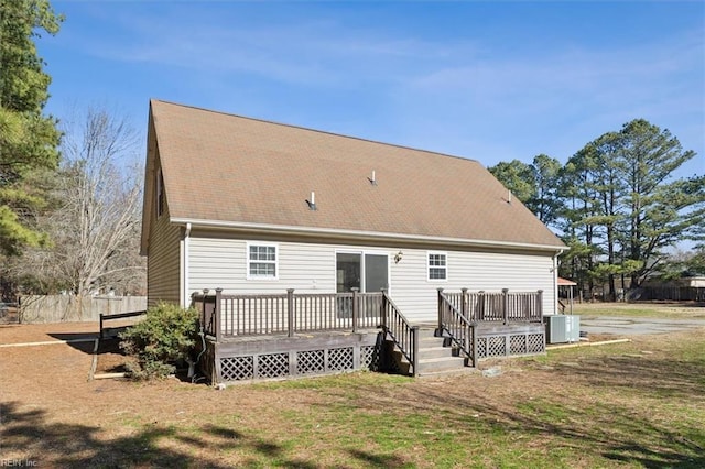 rear view of property featuring a wooden deck, a yard, and central AC unit