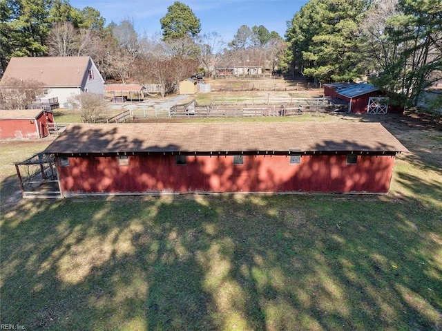 entry to storm shelter featuring a yard and an outbuilding