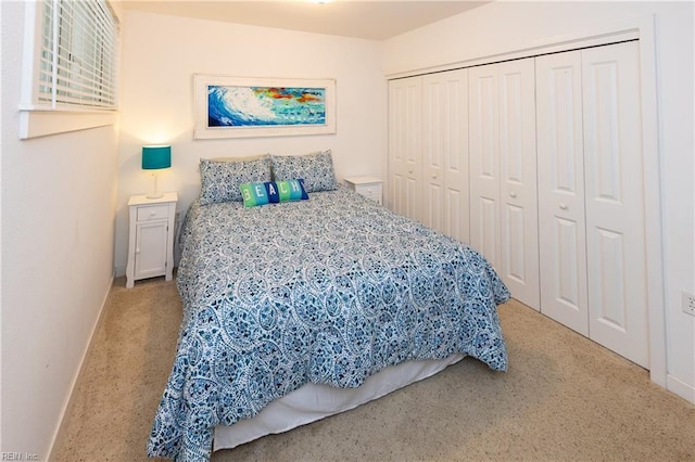 bedroom with light carpet and a closet