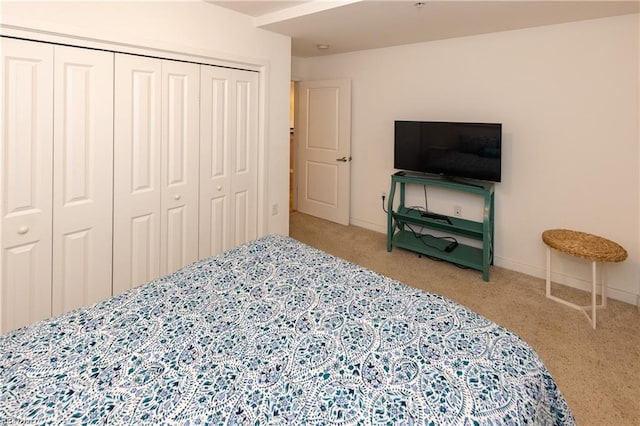 carpeted bedroom featuring a closet