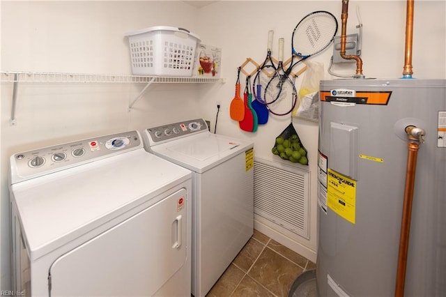 washroom with washing machine and dryer and electric water heater