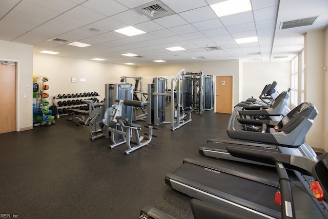 exercise room featuring a drop ceiling