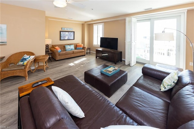 living room with ceiling fan and light hardwood / wood-style flooring