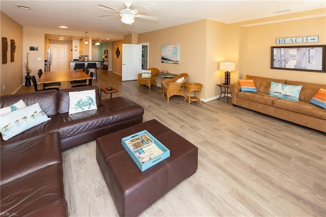 living room featuring hardwood / wood-style flooring and ceiling fan