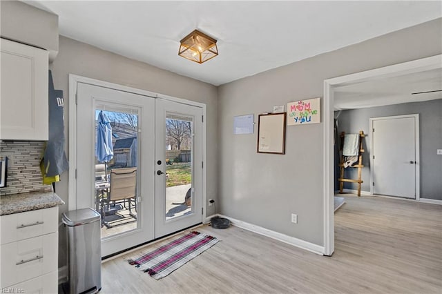 doorway featuring light hardwood / wood-style floors and french doors