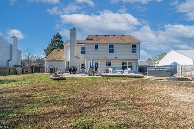 back of property with a lawn, a hot tub, a patio area, and central air condition unit