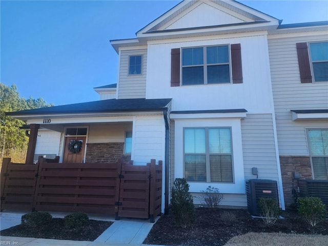 view of front of house with cooling unit and a porch