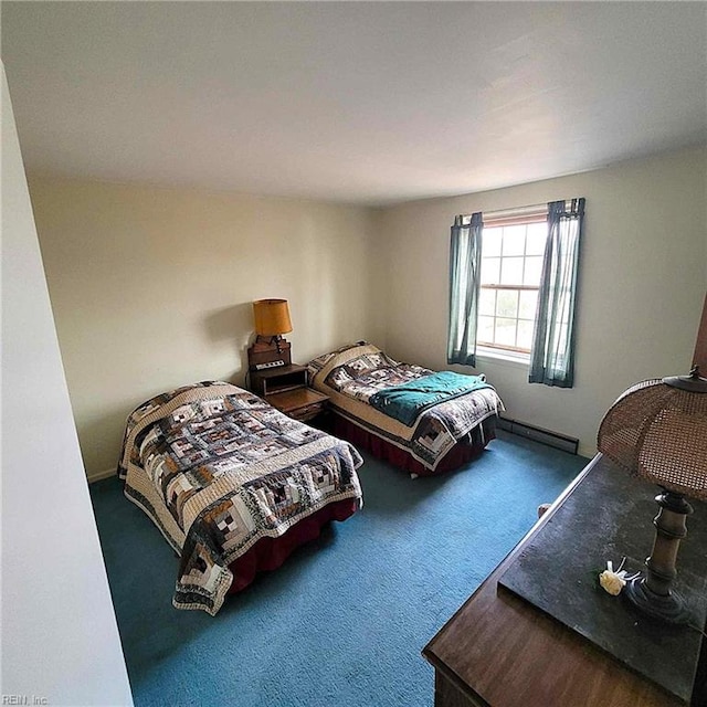 bedroom with carpet floors and baseboard heating