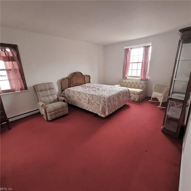 carpeted bedroom featuring baseboard heating