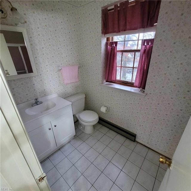 bathroom with a baseboard heating unit, wallpapered walls, vanity, and tile patterned floors