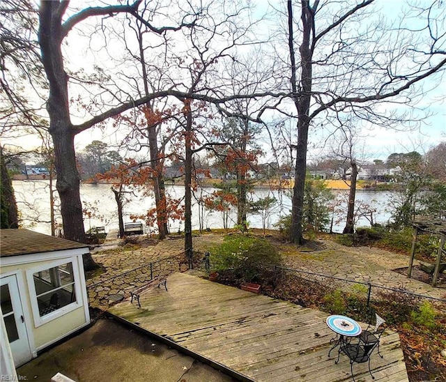 view of yard with a deck with water view