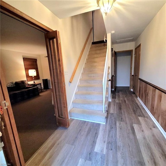 stairs featuring hardwood / wood-style flooring