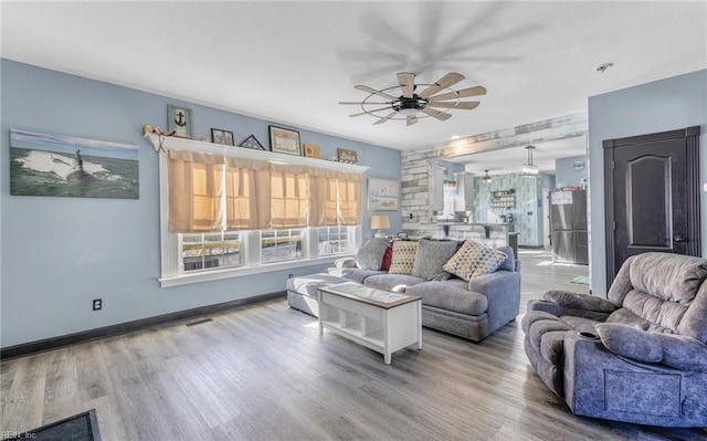 living room with wood-type flooring, a healthy amount of sunlight, and ceiling fan