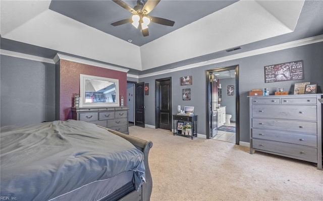 carpeted bedroom with a raised ceiling and ceiling fan