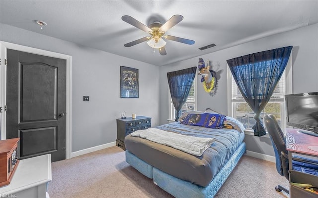 bedroom featuring light carpet and ceiling fan