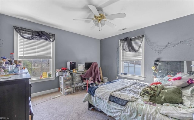 bedroom with multiple windows, carpet, and ceiling fan