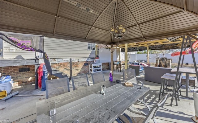 exterior space featuring a gazebo, an outdoor bar, and a patio area