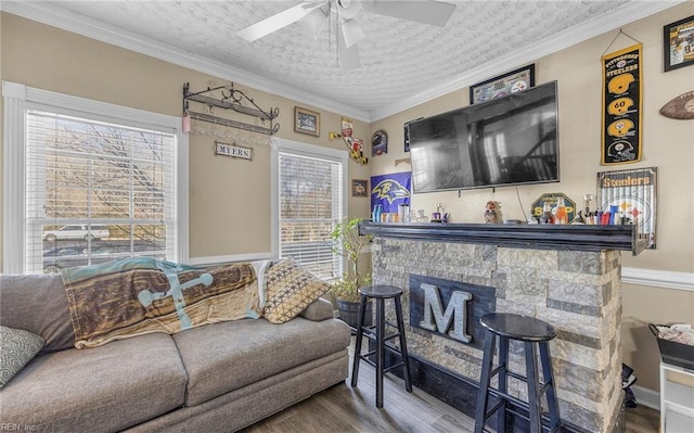 living room featuring crown molding, hardwood / wood-style floors, ceiling fan, and a textured ceiling