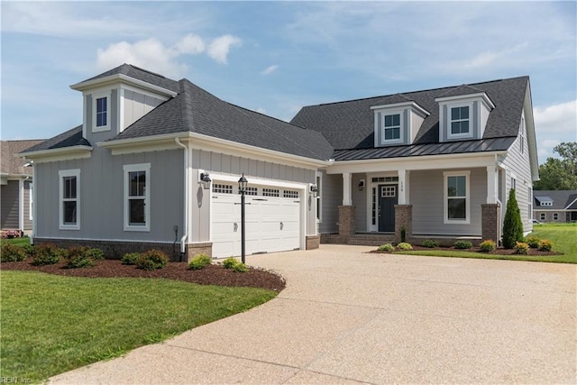 view of front of house with a porch, a garage, and a front yard