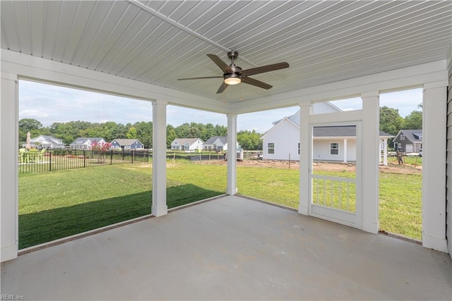 unfurnished sunroom featuring ceiling fan