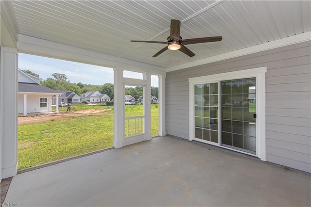 unfurnished sunroom featuring ceiling fan