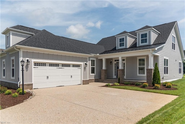 view of front facade featuring a garage and covered porch