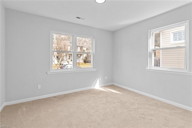 spare room with light colored carpet