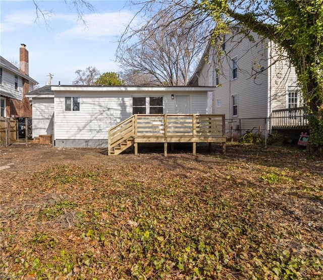 back of property featuring a deck