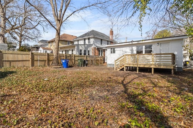 rear view of house with a wooden deck